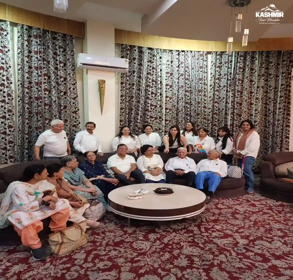 Guests celebrating with a cake cutting ceremony at a hotel during their Kashmir tour