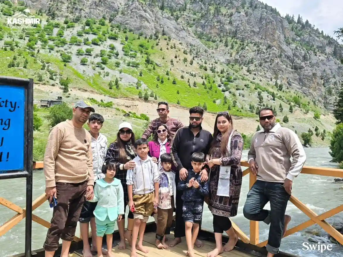 Group family clients enjoying a riverside picnic during their Kashmir tour with Kashmir Tour Provider